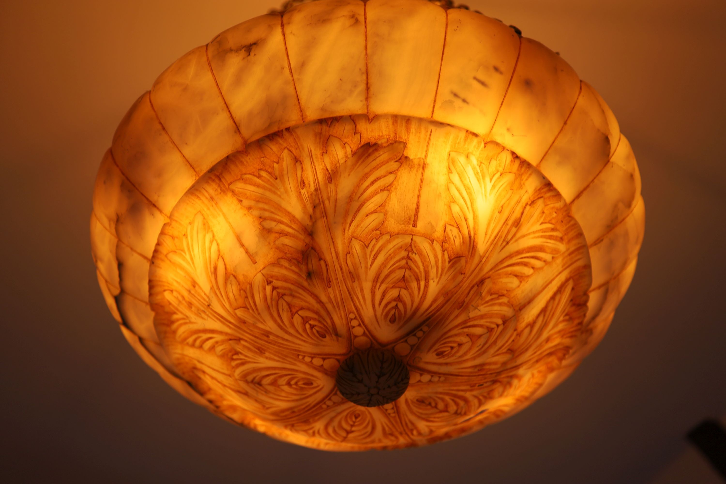 A foliate carved alabaster light bowl, diameter 56cm drop including chains 90cm